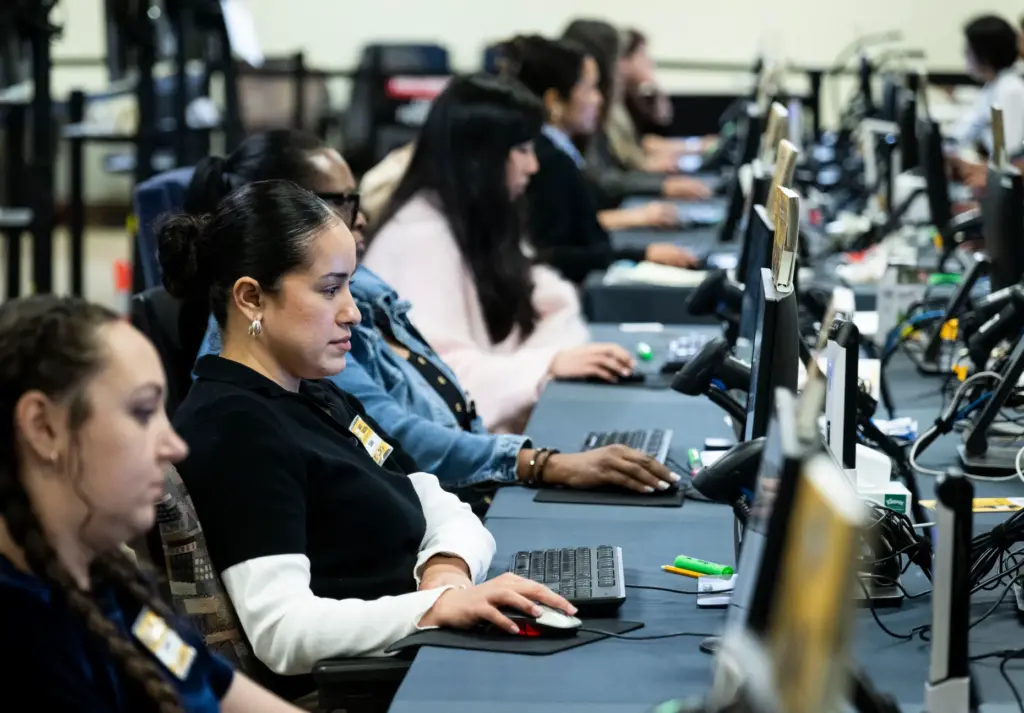 People work in signature verification at the Orange County Registrar...