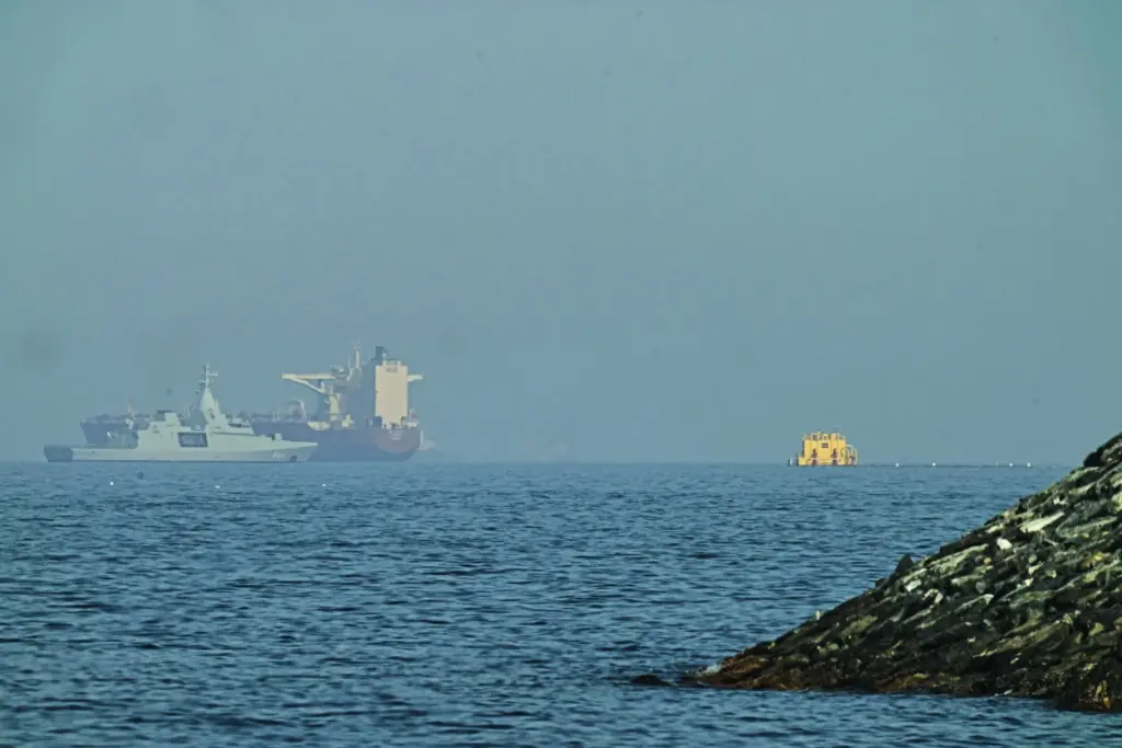An Emirati patrol boat is near a tanker anchored in the Gulf of Oman.