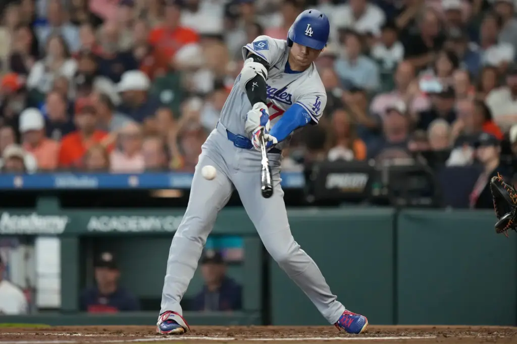 Dodgers star Shohei Ohtani hits a double during the third...