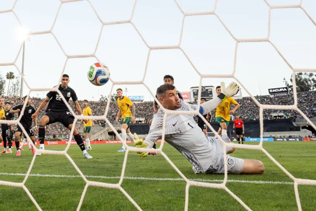 Australia goalkeeper Mathew Ryan, right, watches the ball go past...