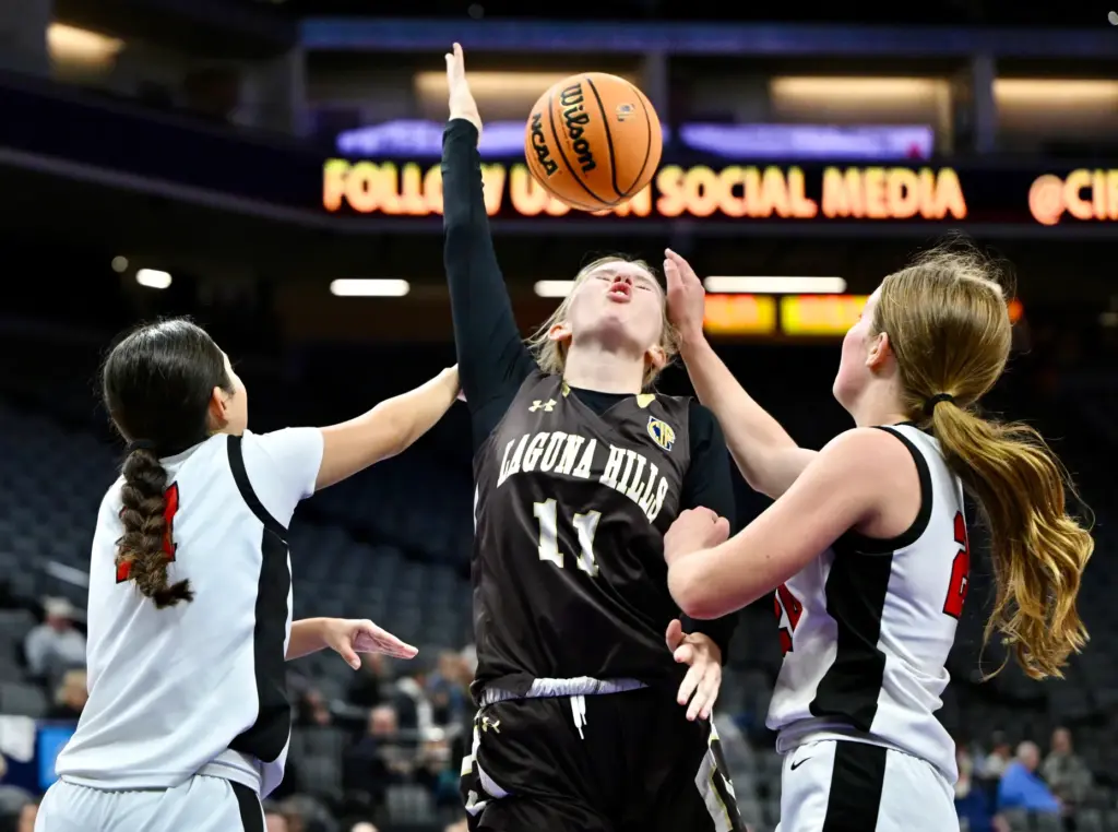 Keira McDermott #11 of Laguna Hills reaches for the rebound...