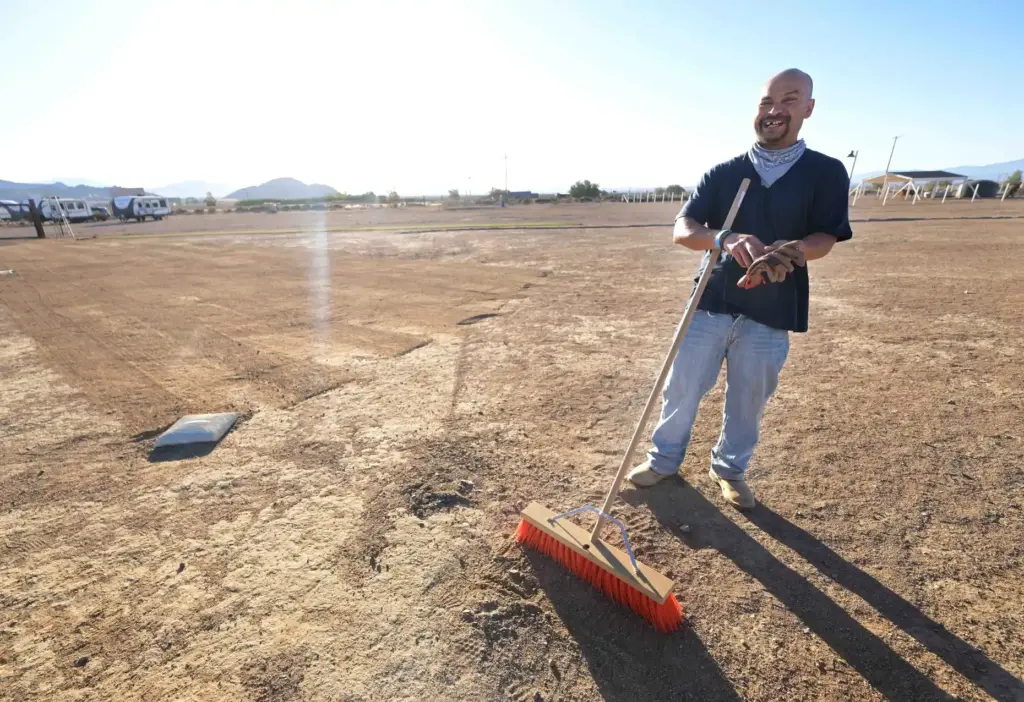 âRancherâ Raymond Ramirez, 43, grooms a softball diamond at the...