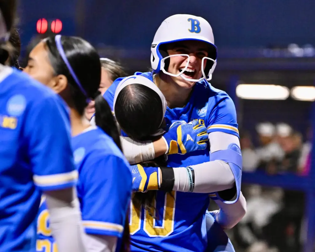 Aleena Garcia #21 of the UCLA Bruins jumps into the...