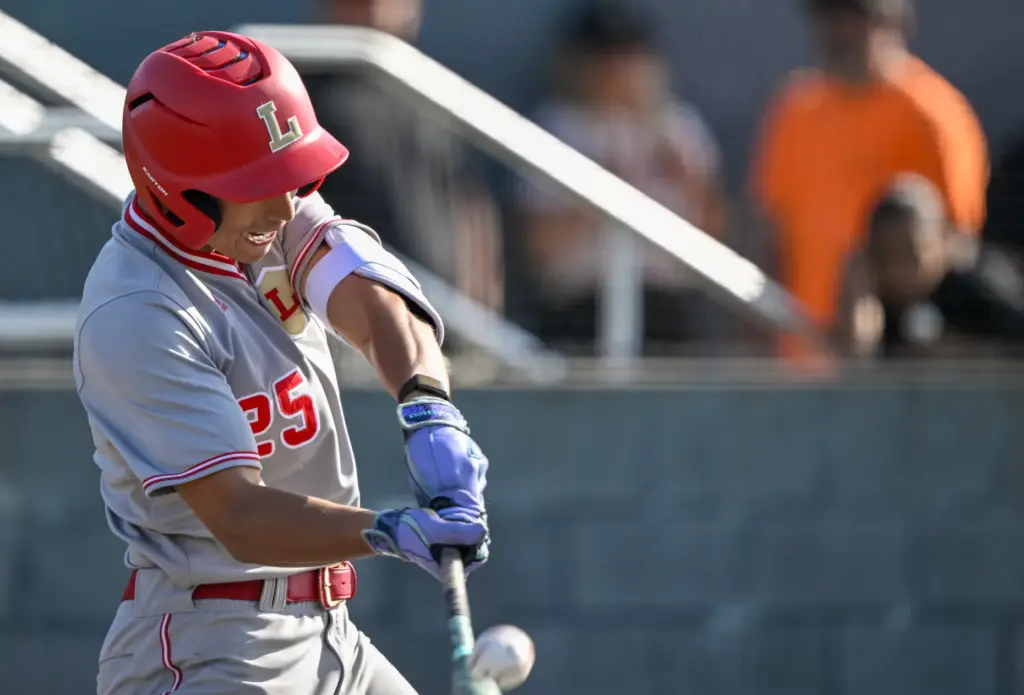 Orange Lutheran outfielder Eric Zdunek hits the ball during a...