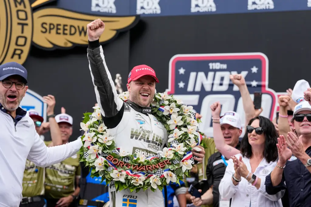 Felix Rosenqvist, center, of Sweden, celebrates after winning the Indianapolis...