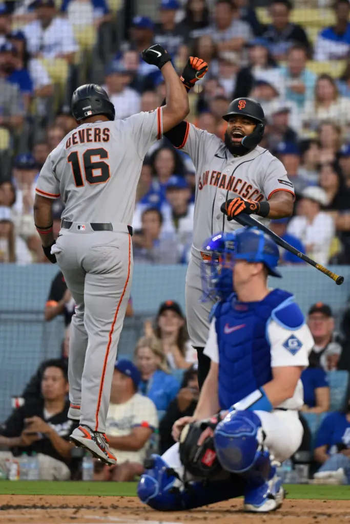 San Francisco Giants designated hitter Rafael Devers, left, celebrates his...