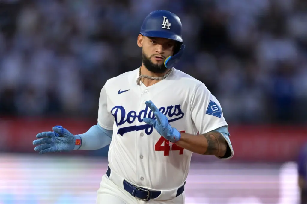 The Dodgers’ Andy Pages gestures to his dugout as he...
