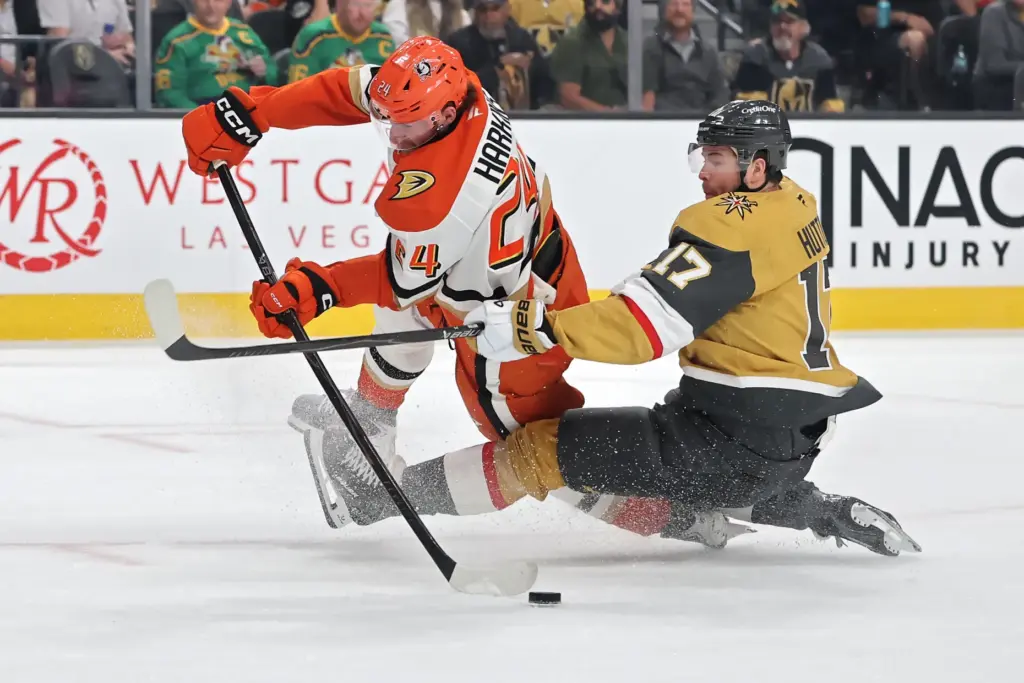 The Ducks’ Jansen Harkins, left, gets knocked down by the...