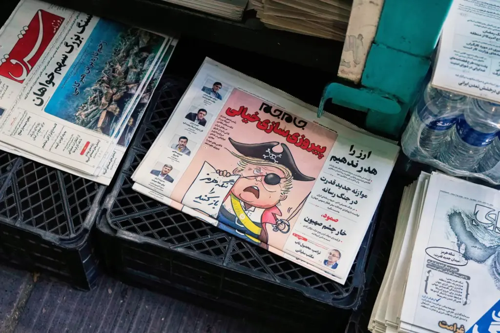 An Iranian newspaper, Jamejam, is seen with a cartoon satirizing President Donald Trump.