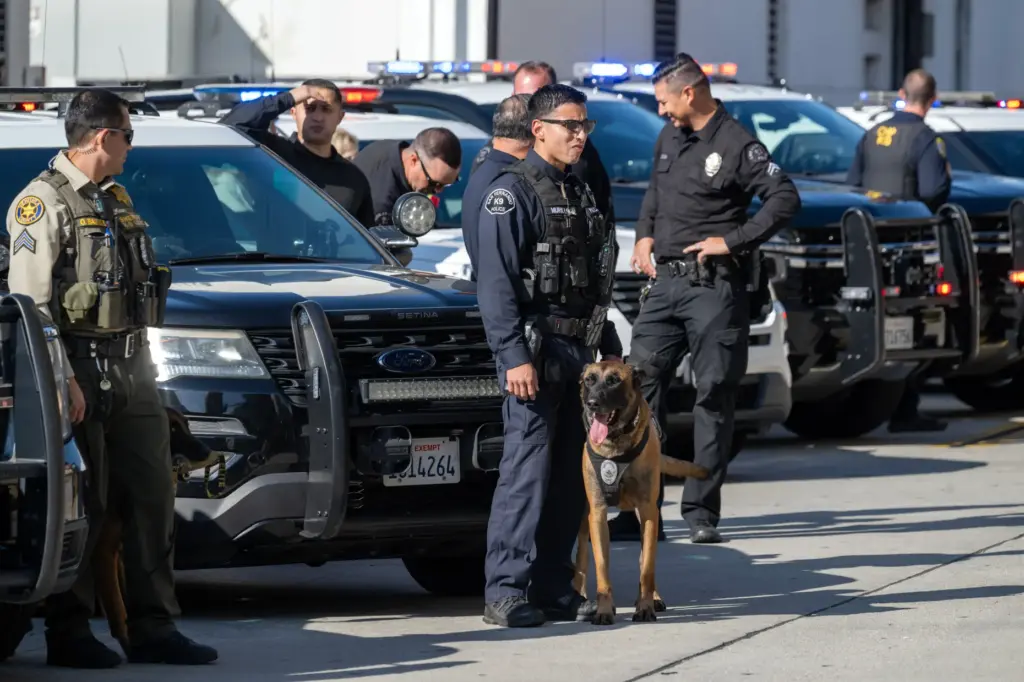 Law enforcement officers line the street during a memorial ceremony...