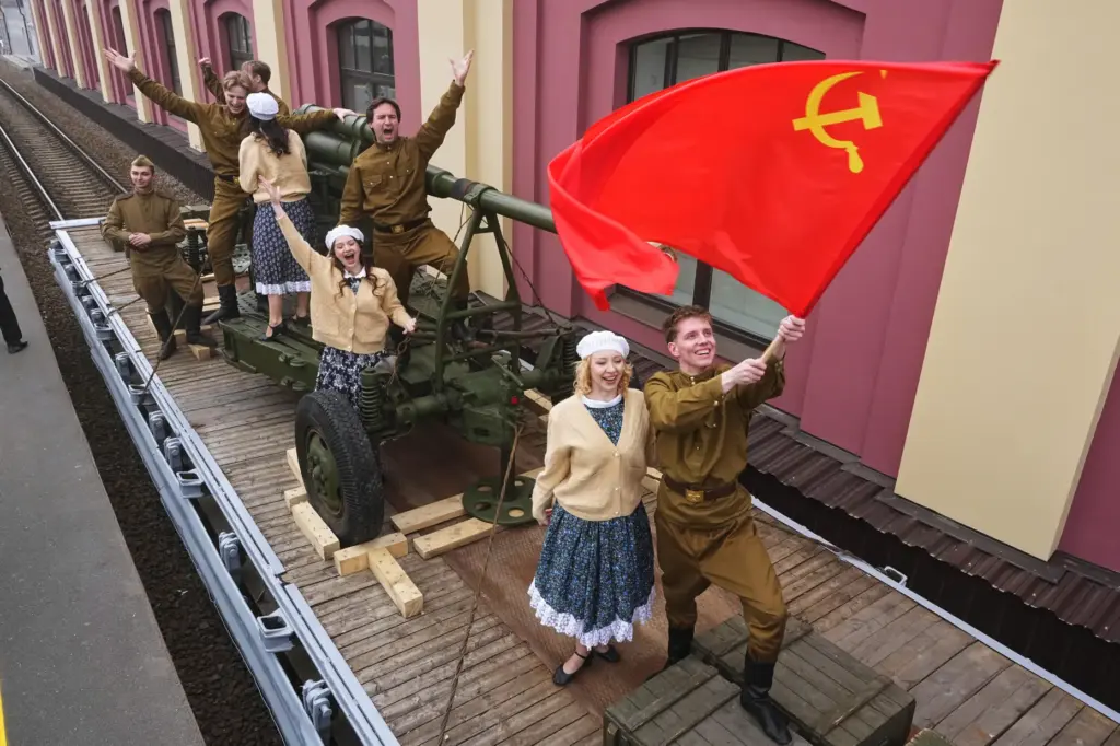 Actors attend a historical reenactment depicting the arrival of trains after the end of World War II.