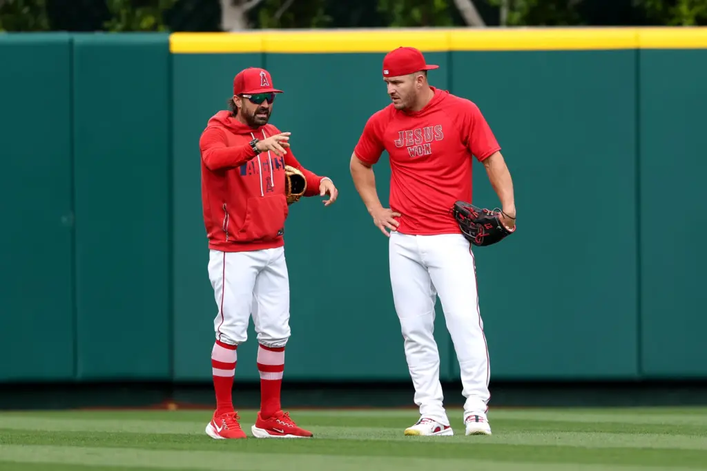 Angels center fielder Mike Trout, right, speaks to outfield coach...