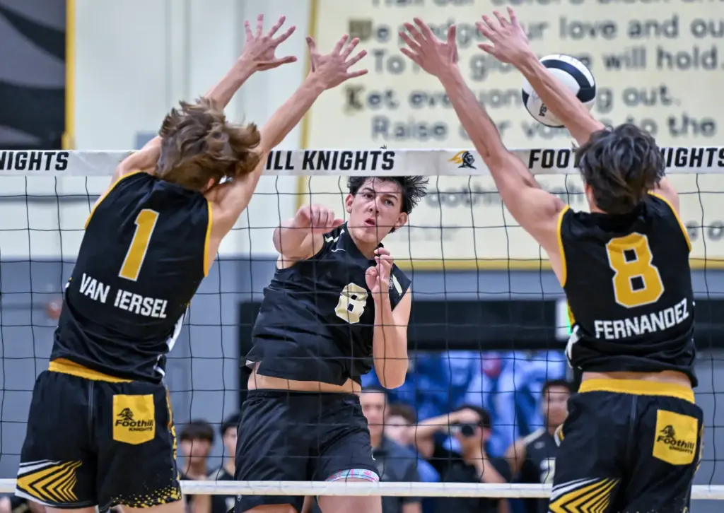 Foothill outside hitter Jonah Van lersel, left, and middle blocker...