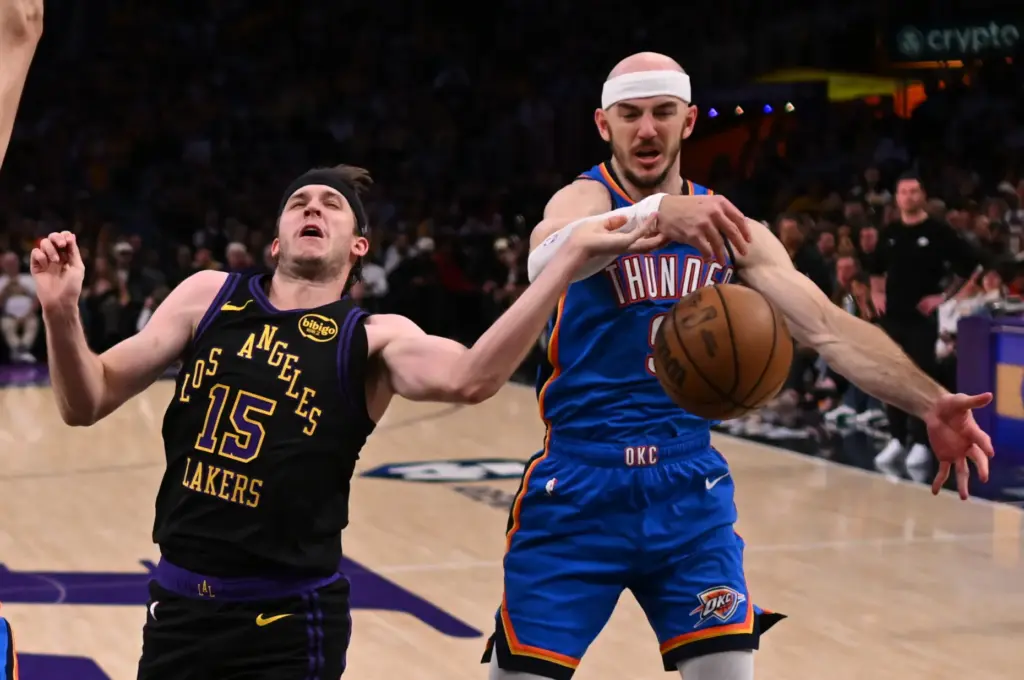 Lakers guard Austin Reaves, left, is fouled by Oklahoma City...