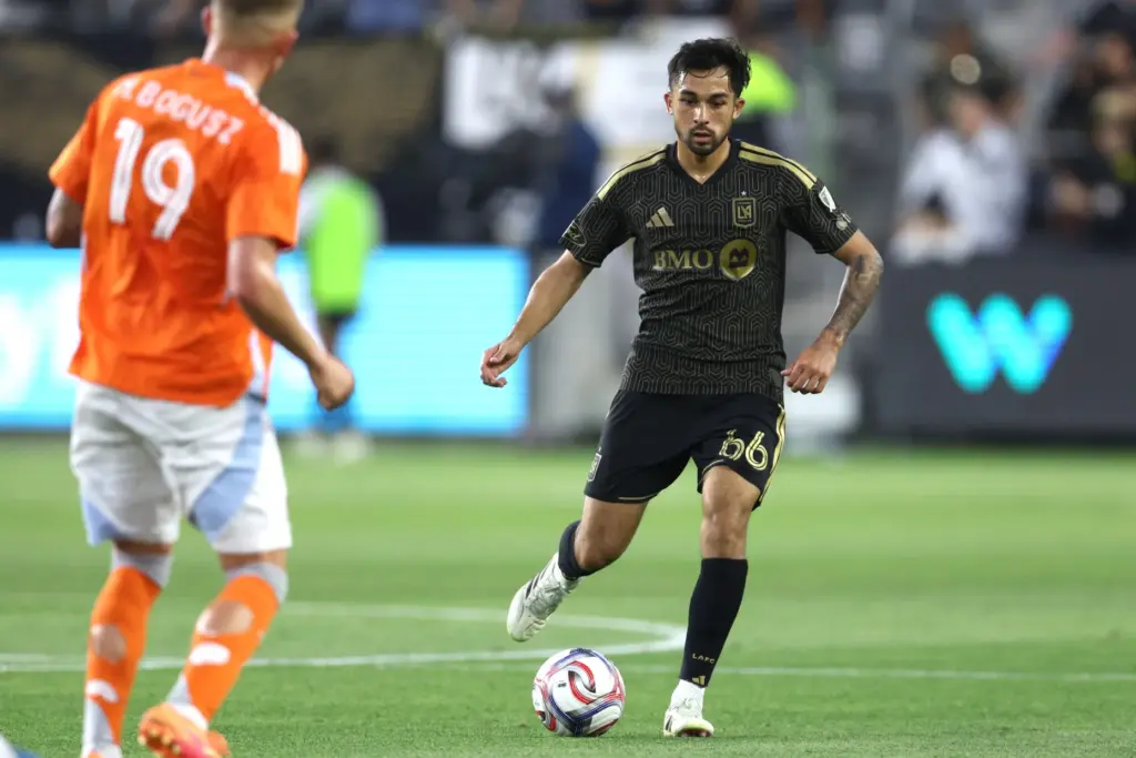 LAFC midfielder Mathieu ChoiniÃ¨re (66) kicks the ball against the...