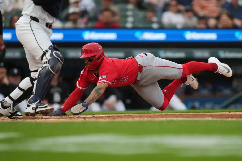 The Angels’ Zach Neto dives safely into home plate to...