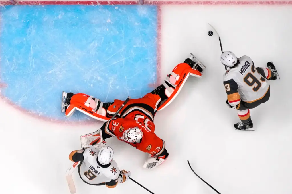 Vegas Golden Knights right wing Mitch Marner, right, scores behind...