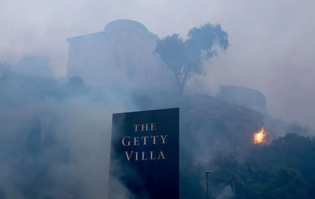 Smoke and flames surround the Villa de Leon along Pacific...