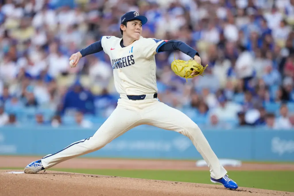 Dodgers starting pitcher Roki Sasaki throws to the plate during...