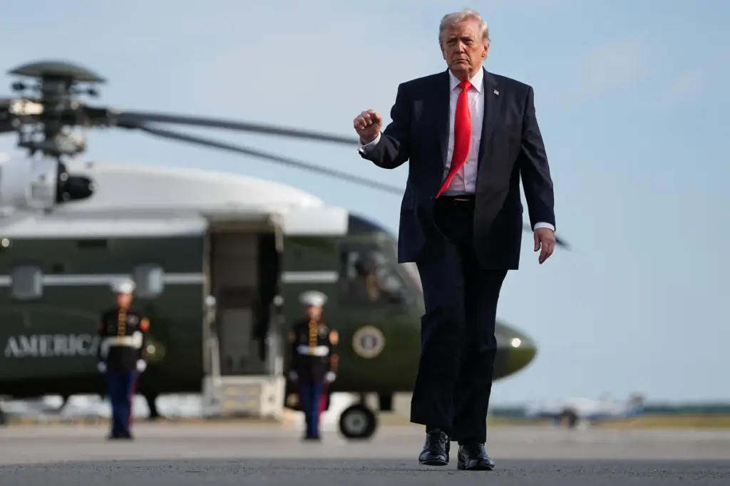 President Donald Trump walks from Marine One to board Air...