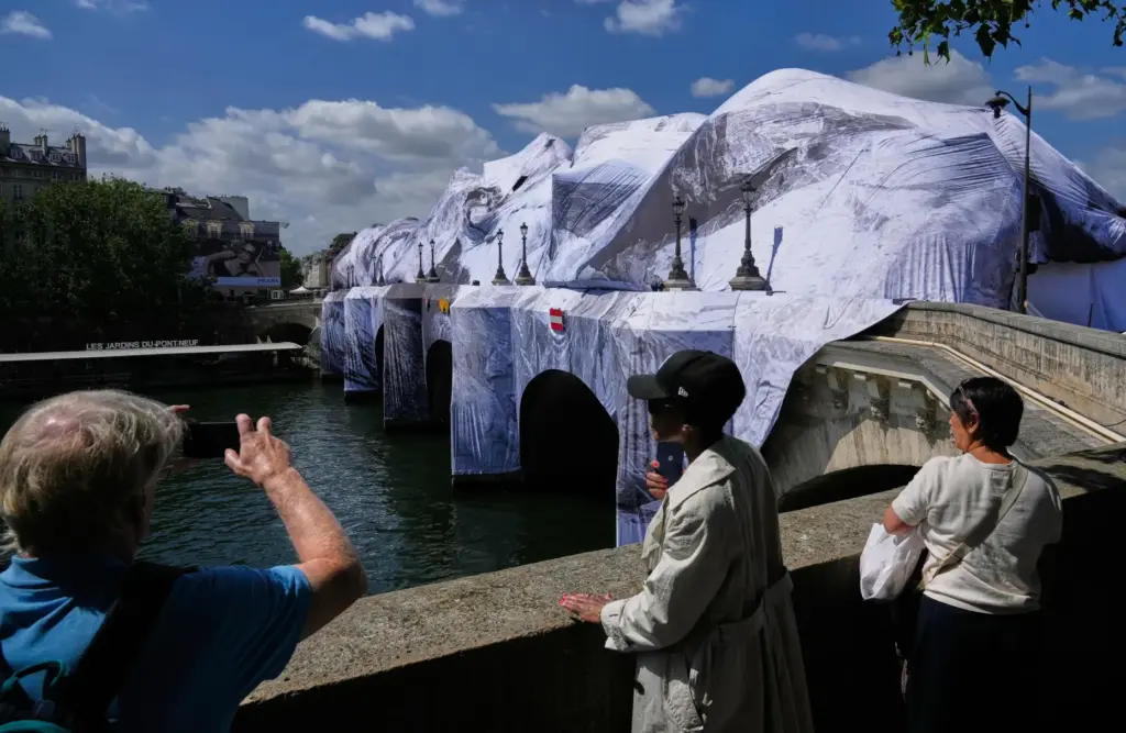 People take pictures of “The Pont Neuf Cave,” an inflated...