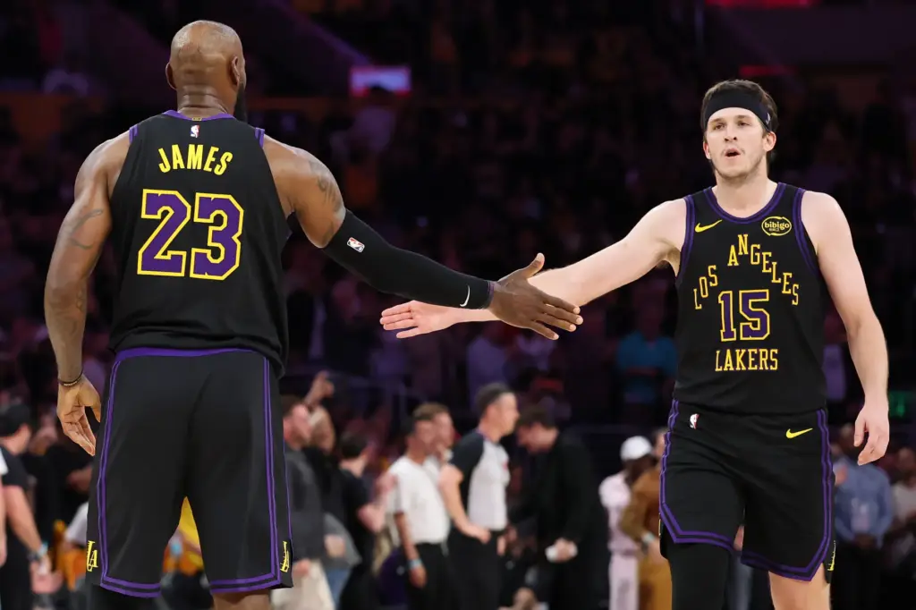 Lakers guard Austin Reaves, right, and forward LeBron James celebrate...