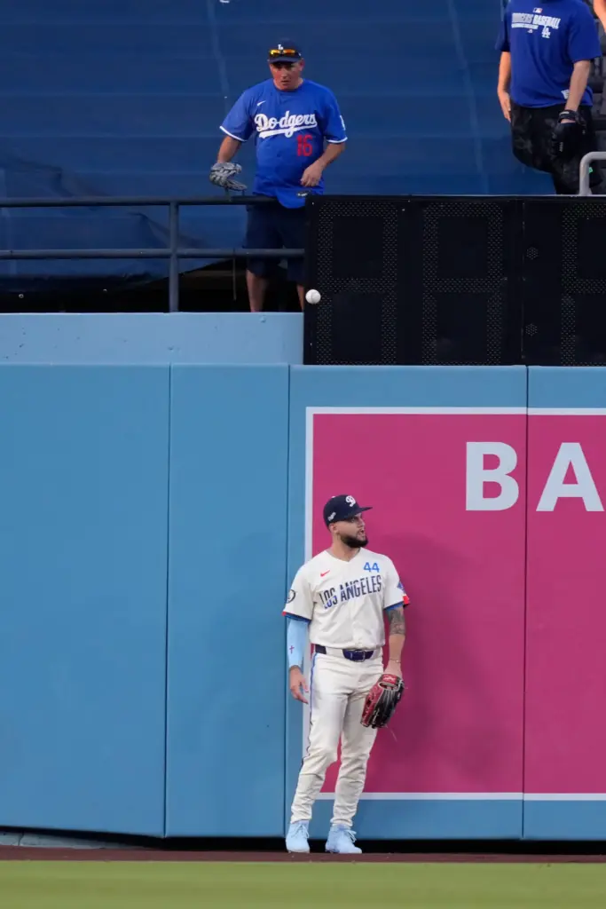 Dodgers center fielder Andy Pages stands as a ball hit...