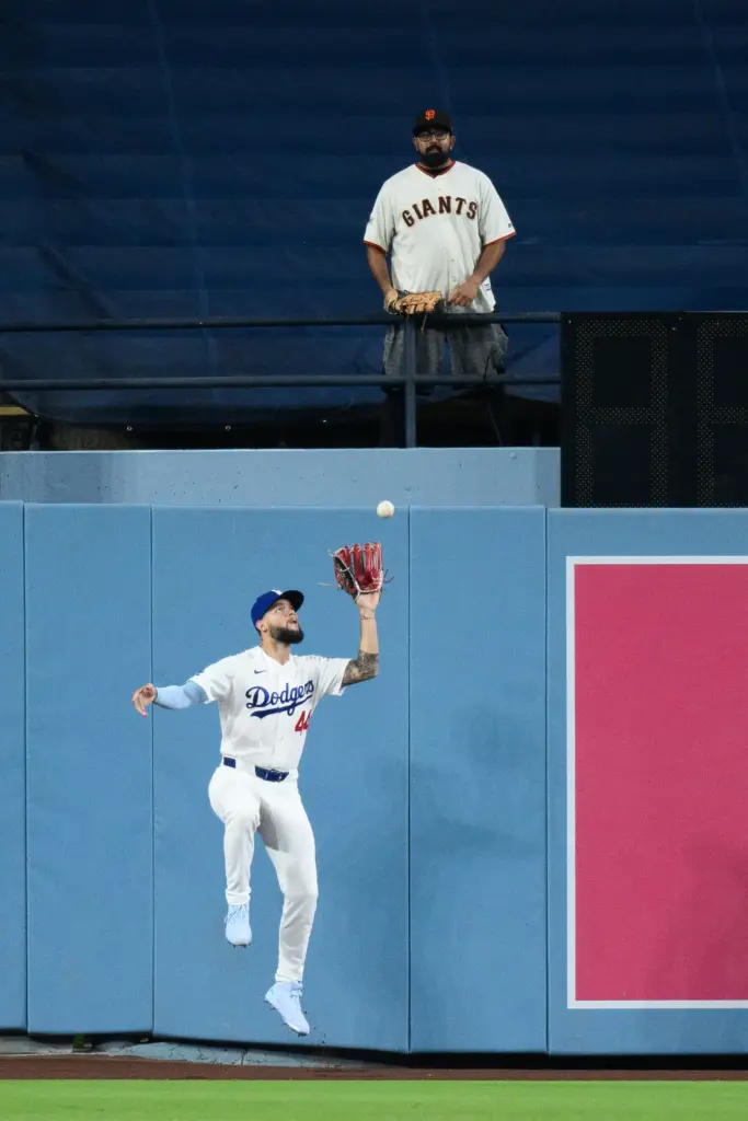 Dodgers center fielder Andy Pages catches a fly ball in...