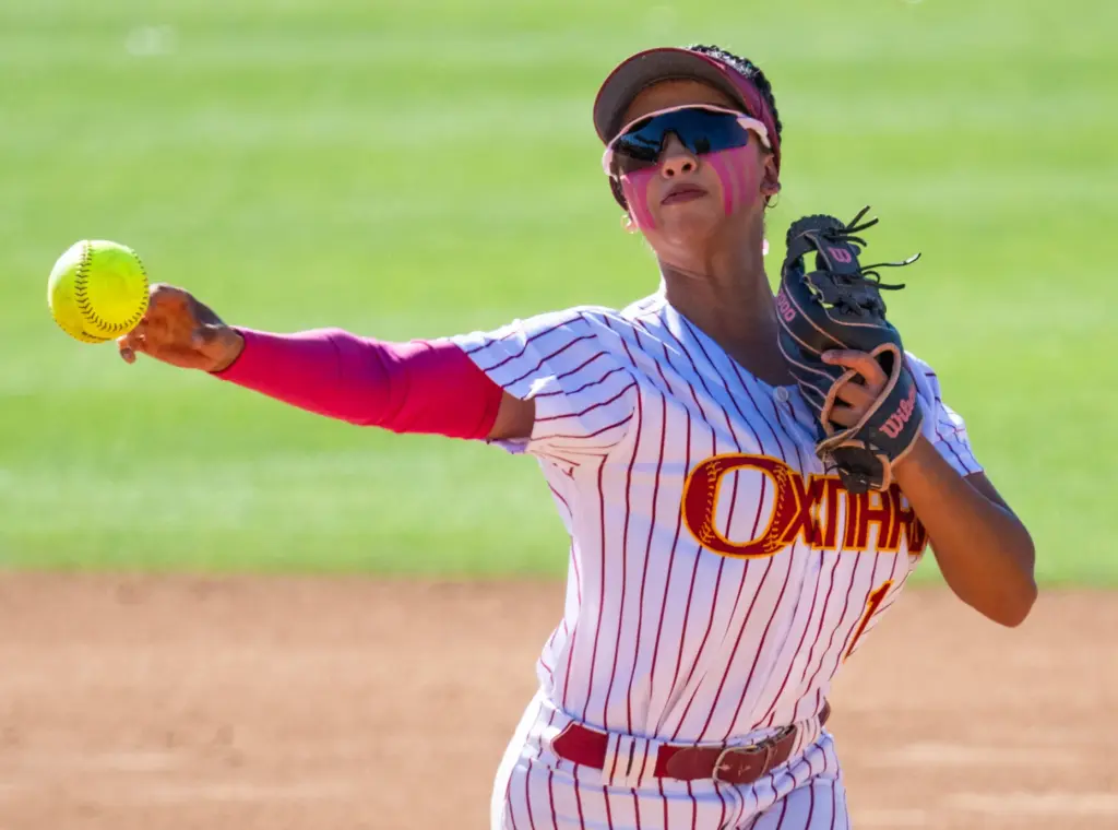 Oxnard shortstop Kayla Lorona throws to first base after fielding...
