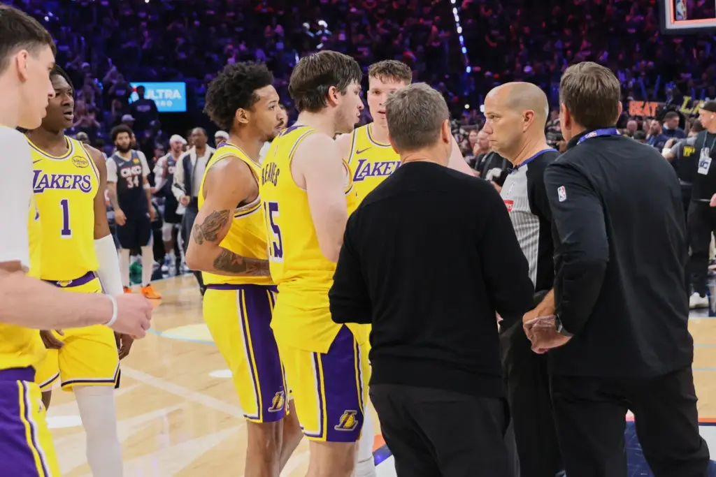 Los Angeles Lakers’ Austin Reaves (15) and other Lakers players...