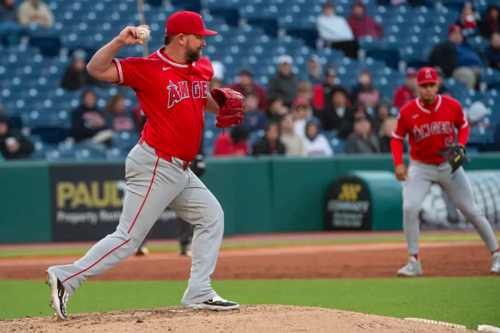 Angels relief pitcher Kirby Yates, left, throws to second base...
