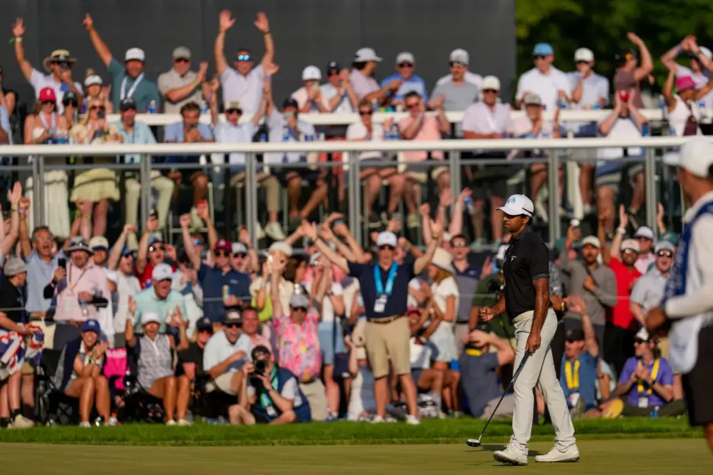 Aaron Rai, of England, celebrates after his shot on the...