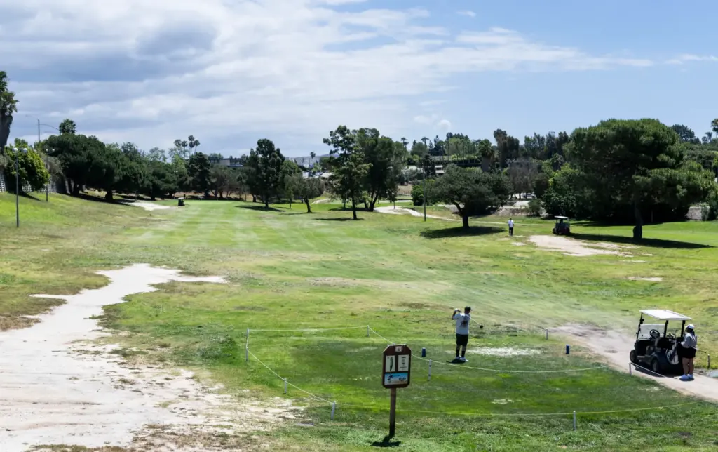 A man tees off at the 4th hole at Newport...