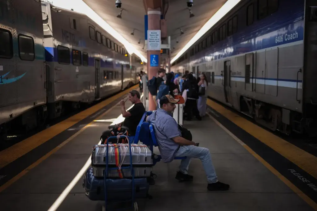 Travelers wait to board an Amtrak train at Union Station...