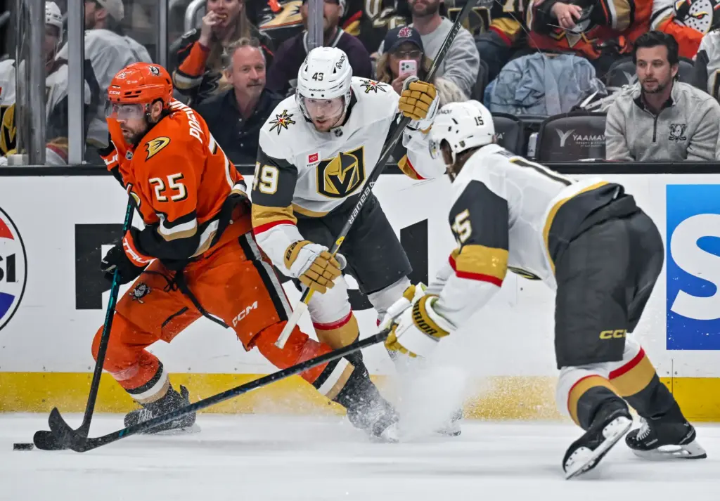The Ducksâ Ryan Poehling (25), left, fends off the Golden...