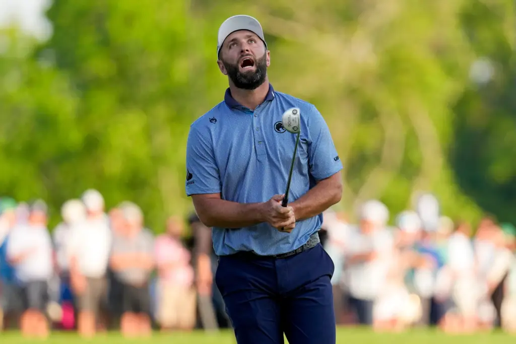 Jon Rahm, of Spain, reacts to missing a putt on...