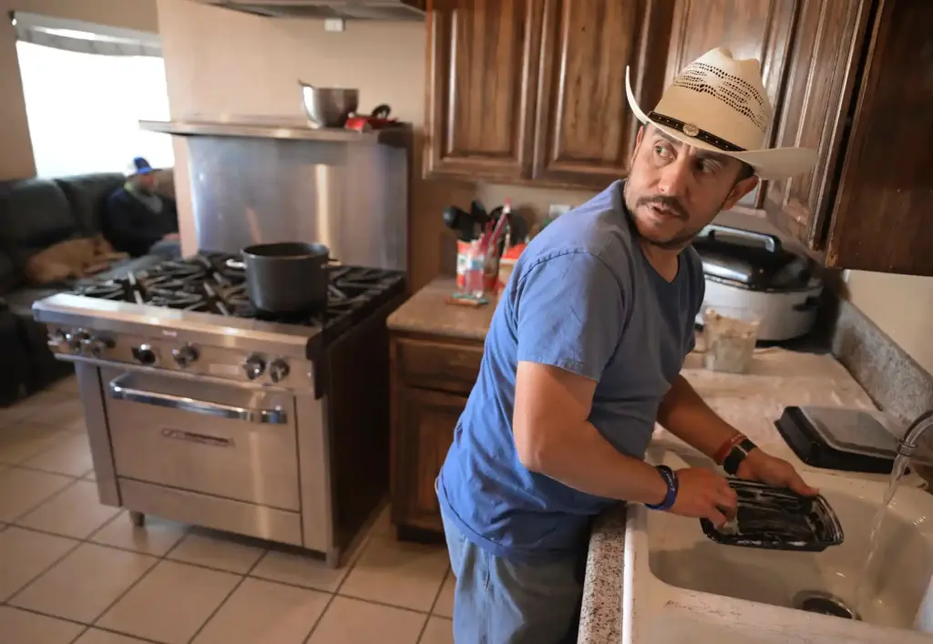 River’s Edge Ranch ârancherâ Rodney Mora, of Fontana, washes dishes...