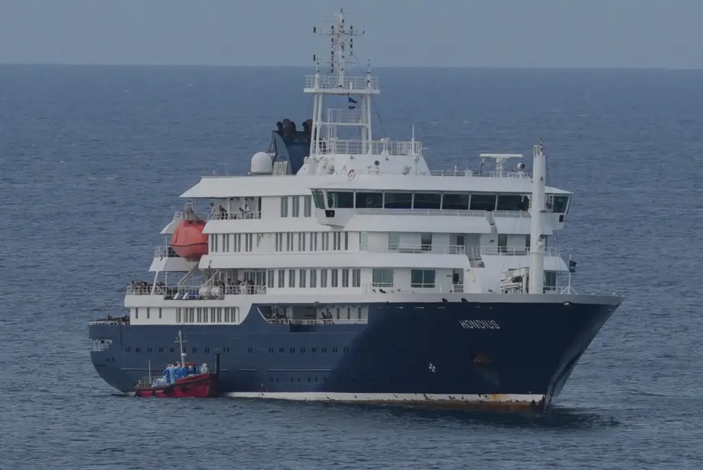 The MV Hondius cruise ship is anchored at a port...