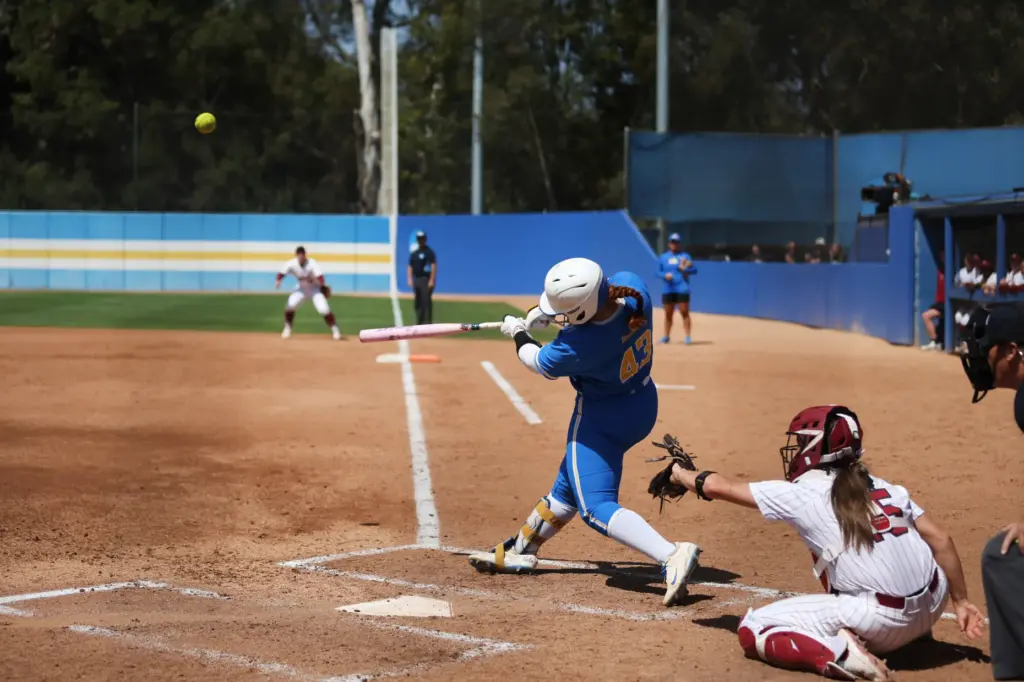 UCLAâs Megan Grant (43) launches the ball for a two-run...