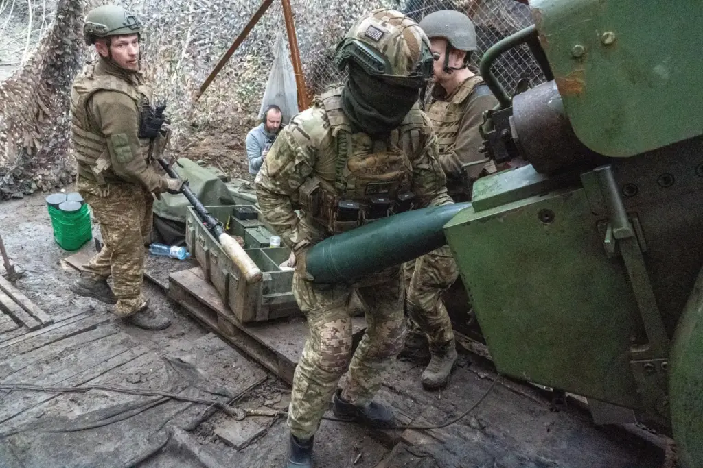 Soldiers from Ukraine's Khartia brigade fire a canon towards Russian army positions.