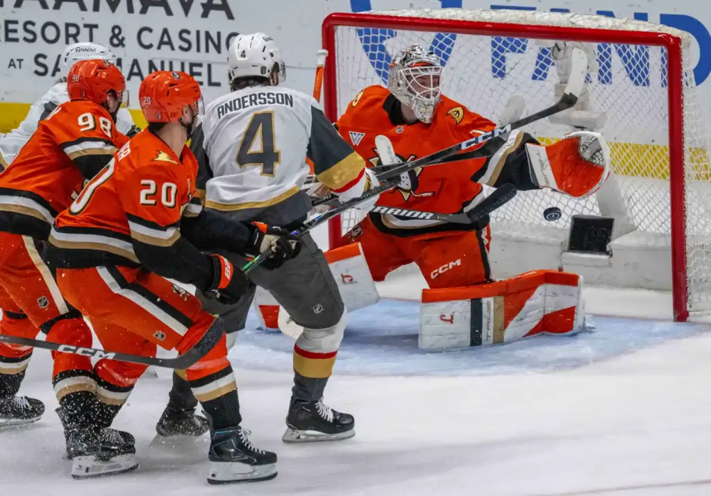 Ducks goaltender Lukas Dostal, right, makes a stop in front...
