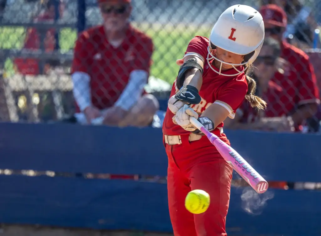 Orange Lutheran second baseman Sierra Nichols hits the ball during...