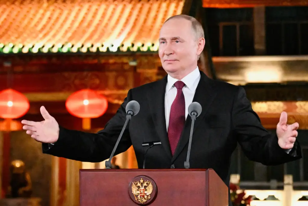 Russian President Vladimir Putin gestures during a news conference.