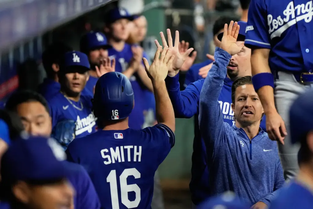 The Dodgers’ Will Smith (16) celebrates in the dugout after...