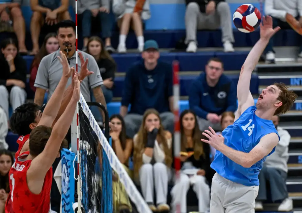 Corona del Mar outside hitter Brady Gant hits the ball...