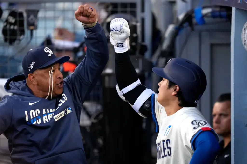Dodgers manager Dave Roberts, left, and Shohei Ohtani greet each...