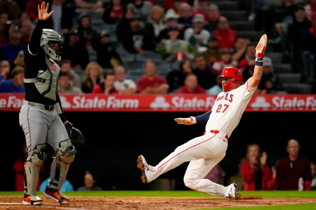 Angels star Mike Trout slides home to score on a...