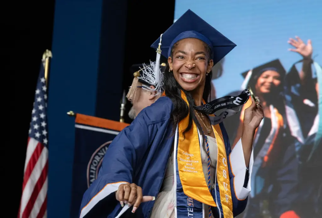 Honor Student Arionn Livingston holds her medallion as she walks...