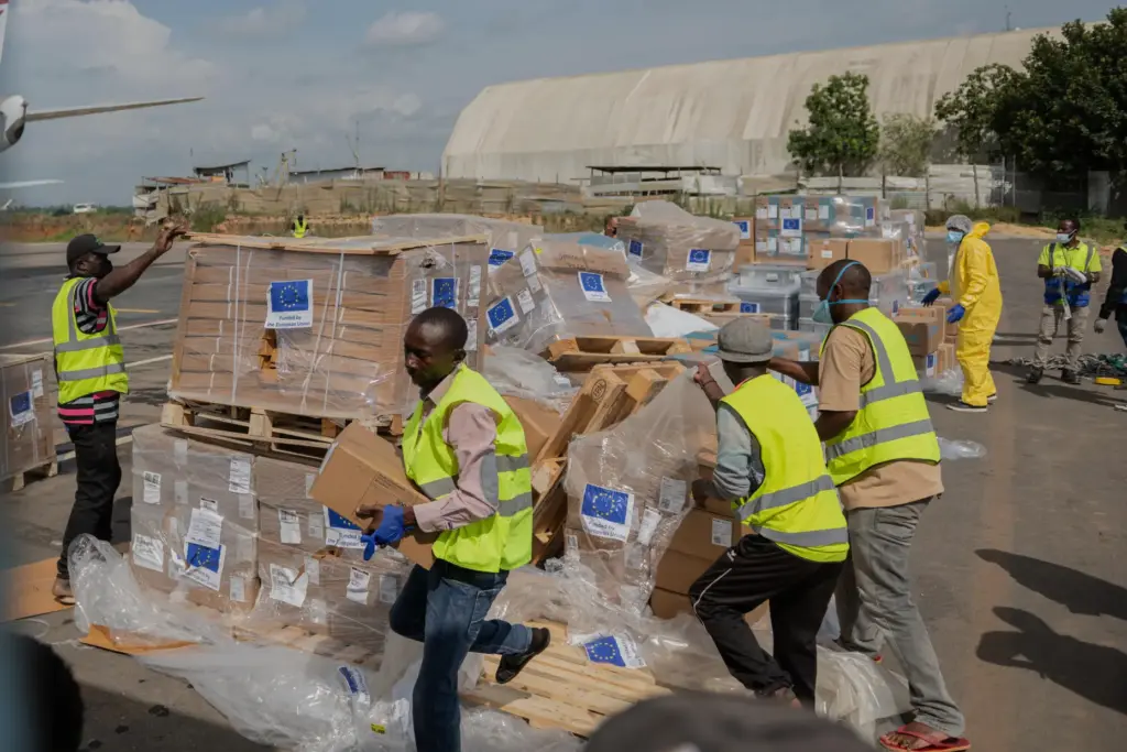Workers offload medical and emergency supplies donated by the European Union.