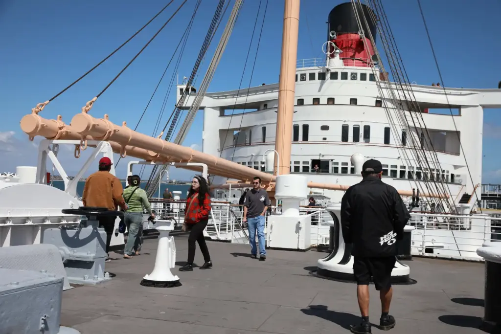 Visitors walk across the bow of the Queen Mary in...